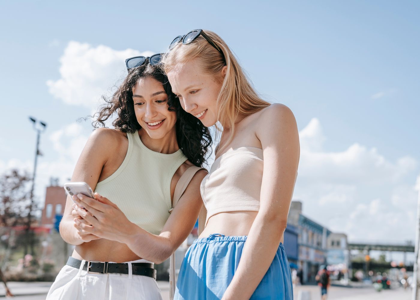 Two happy teens studying the course together on a phone